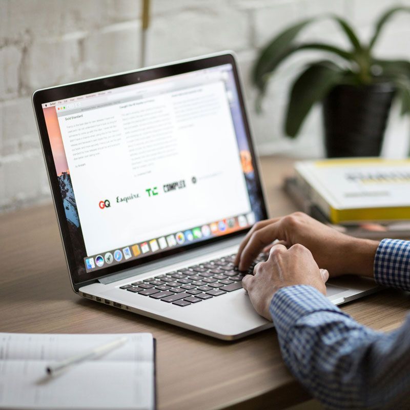 A person is typing on a laptop computer.