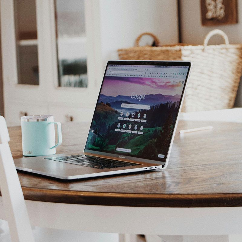 A laptop is open to a google page on a table