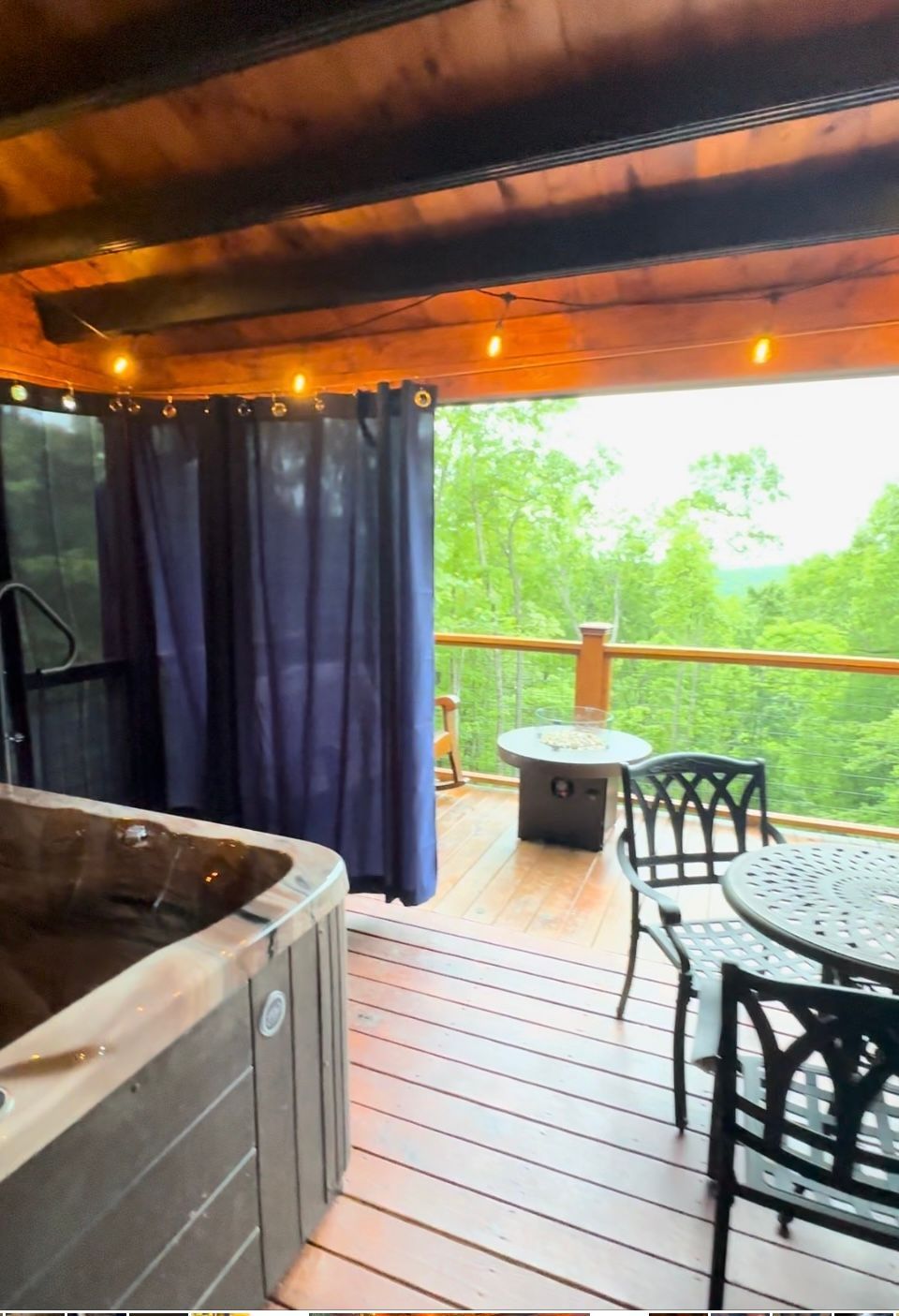 A hot tub on a deck with a table and chairs