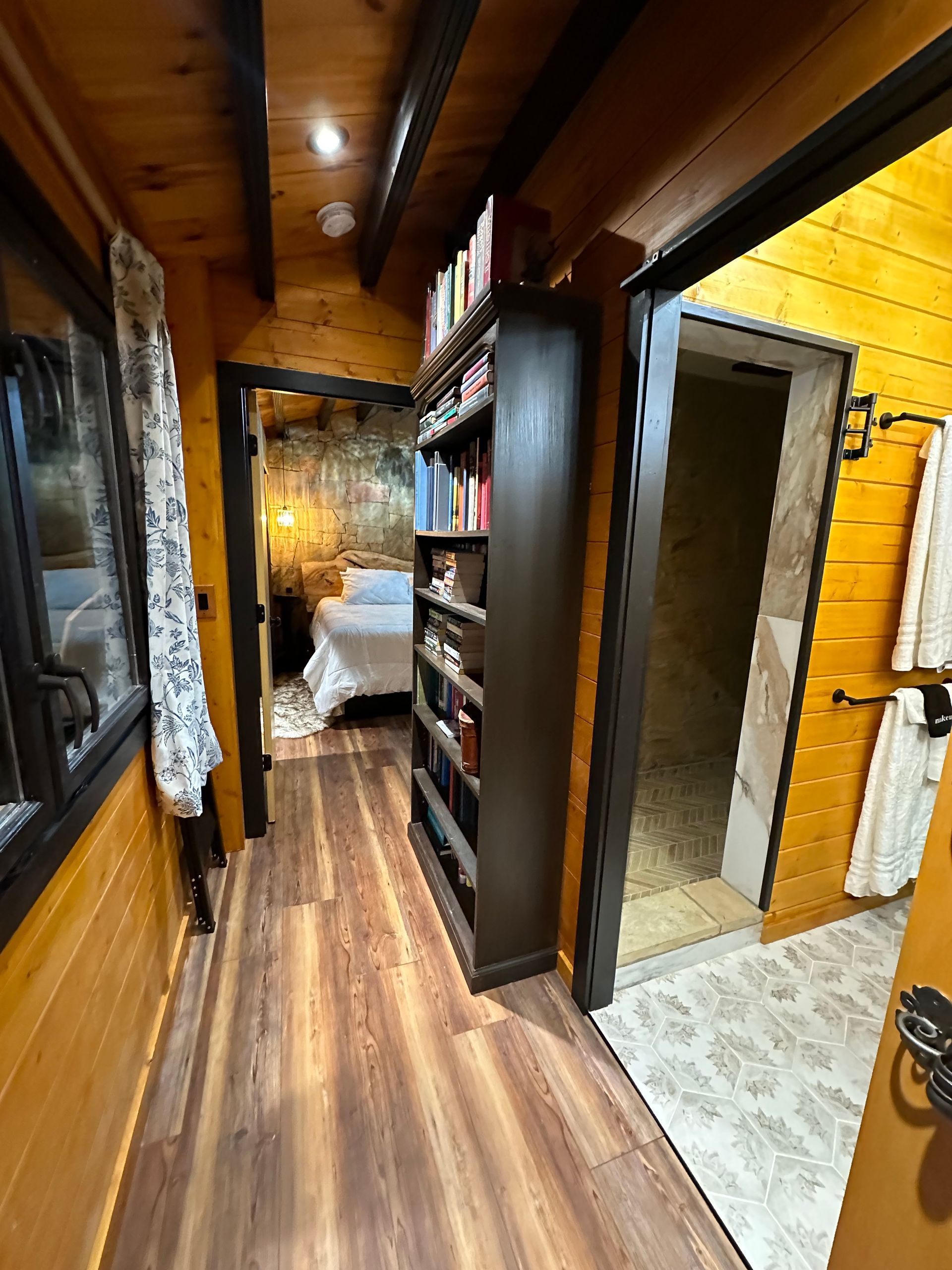 A bathroom in a log cabin with a sink and mirror