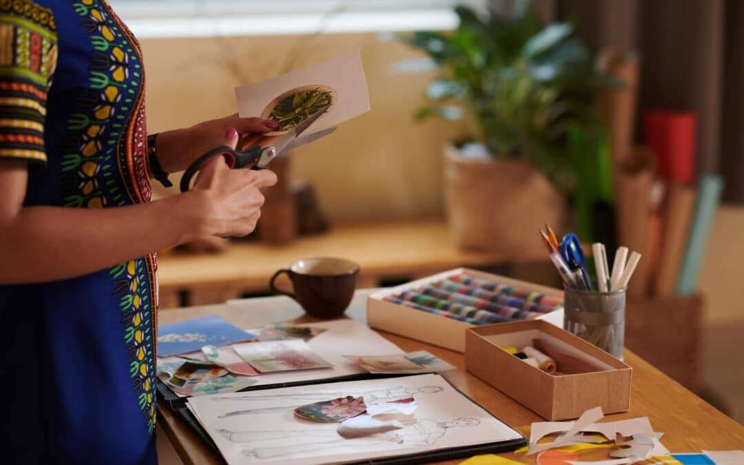 A woman is standing at a table holding a piece of paper.