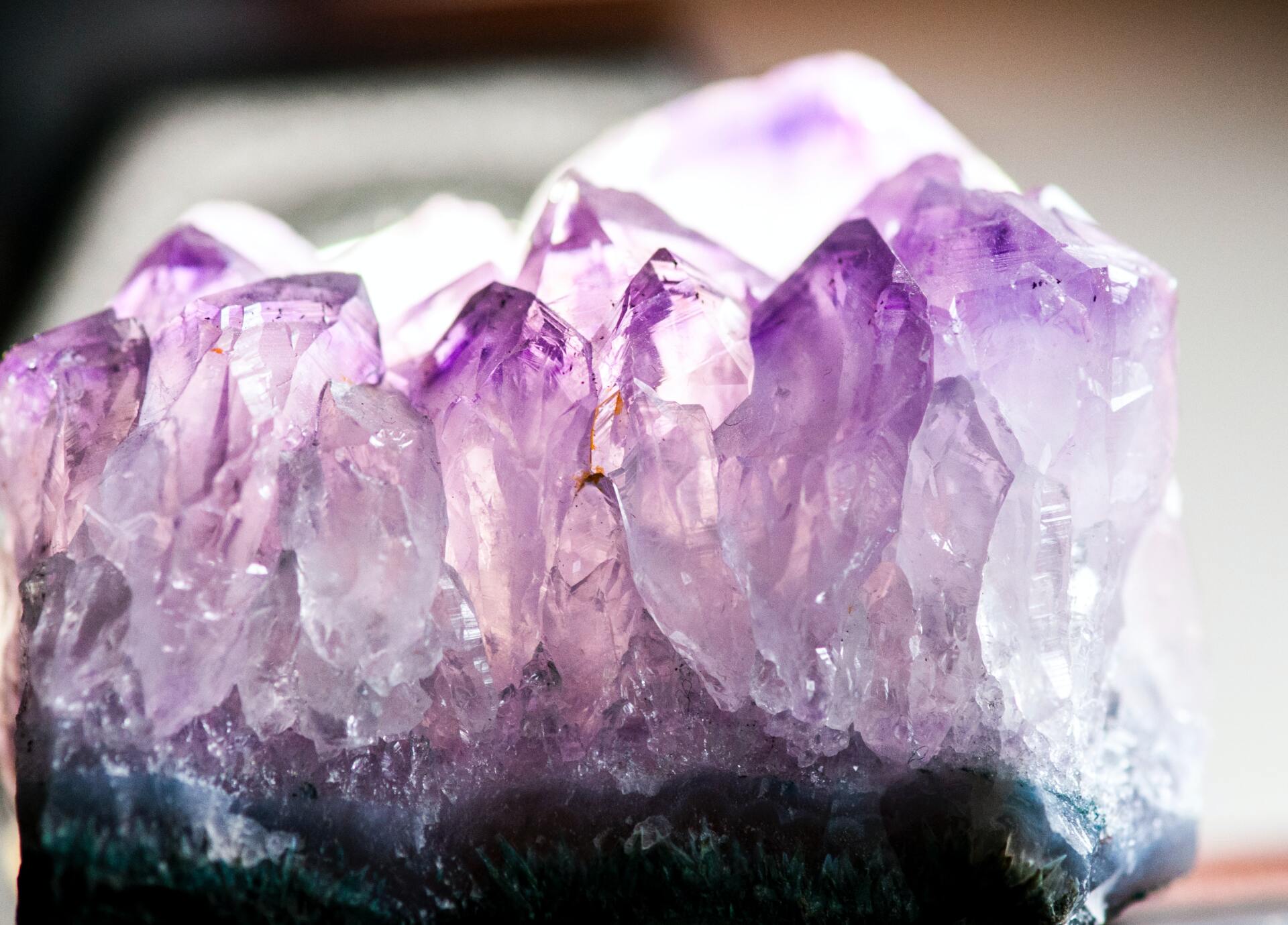 A close up of a purple amethyst crystal on a table.
