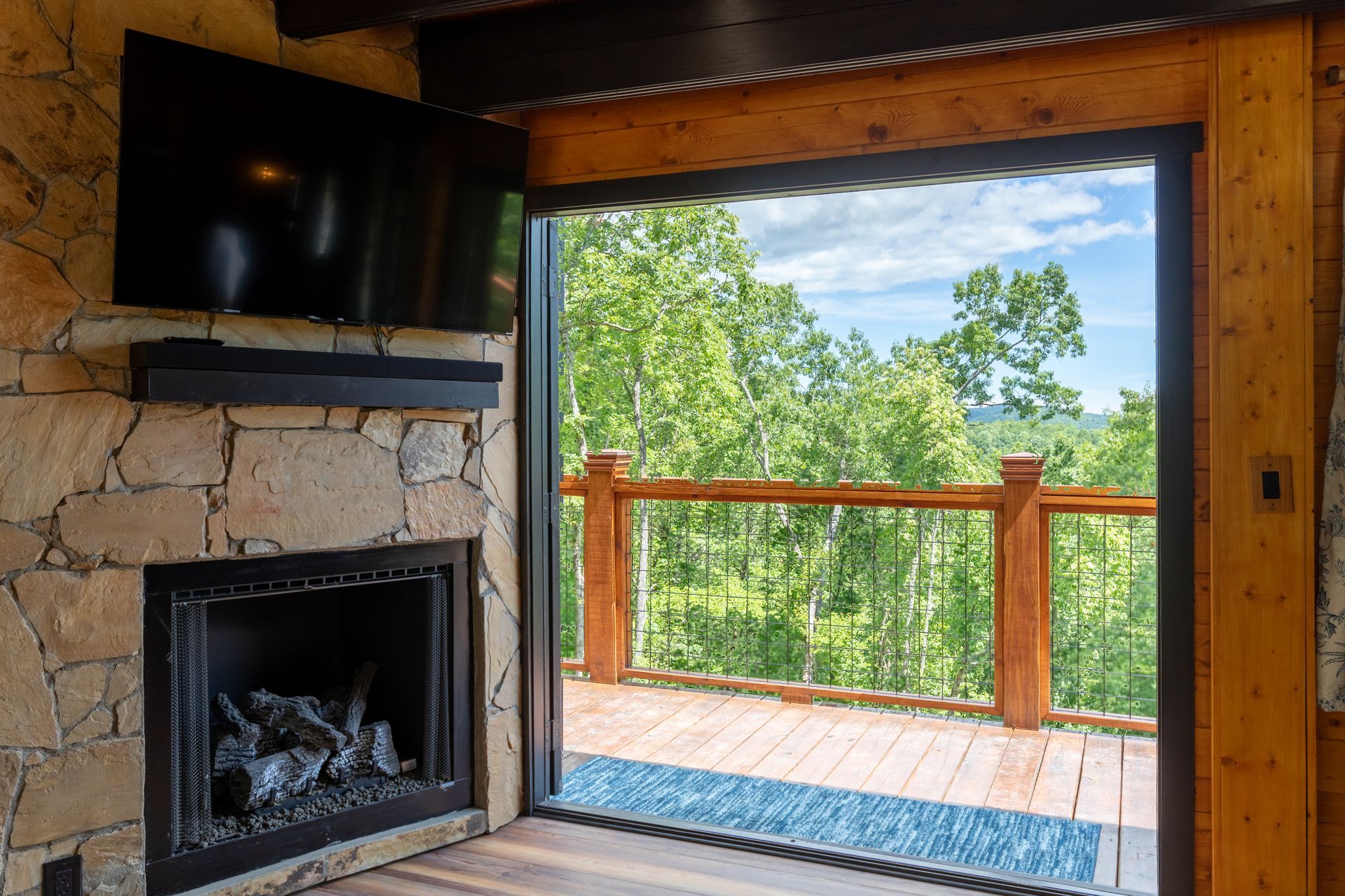There is a hot tub on the deck with a table and chairs.