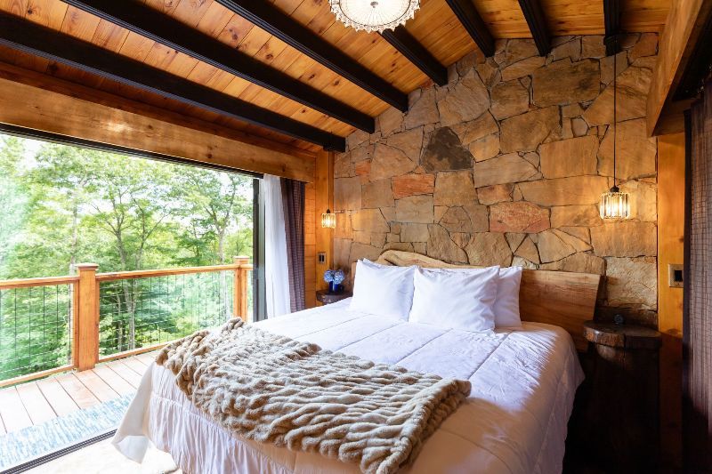 A bedroom with a large bed and a large window.