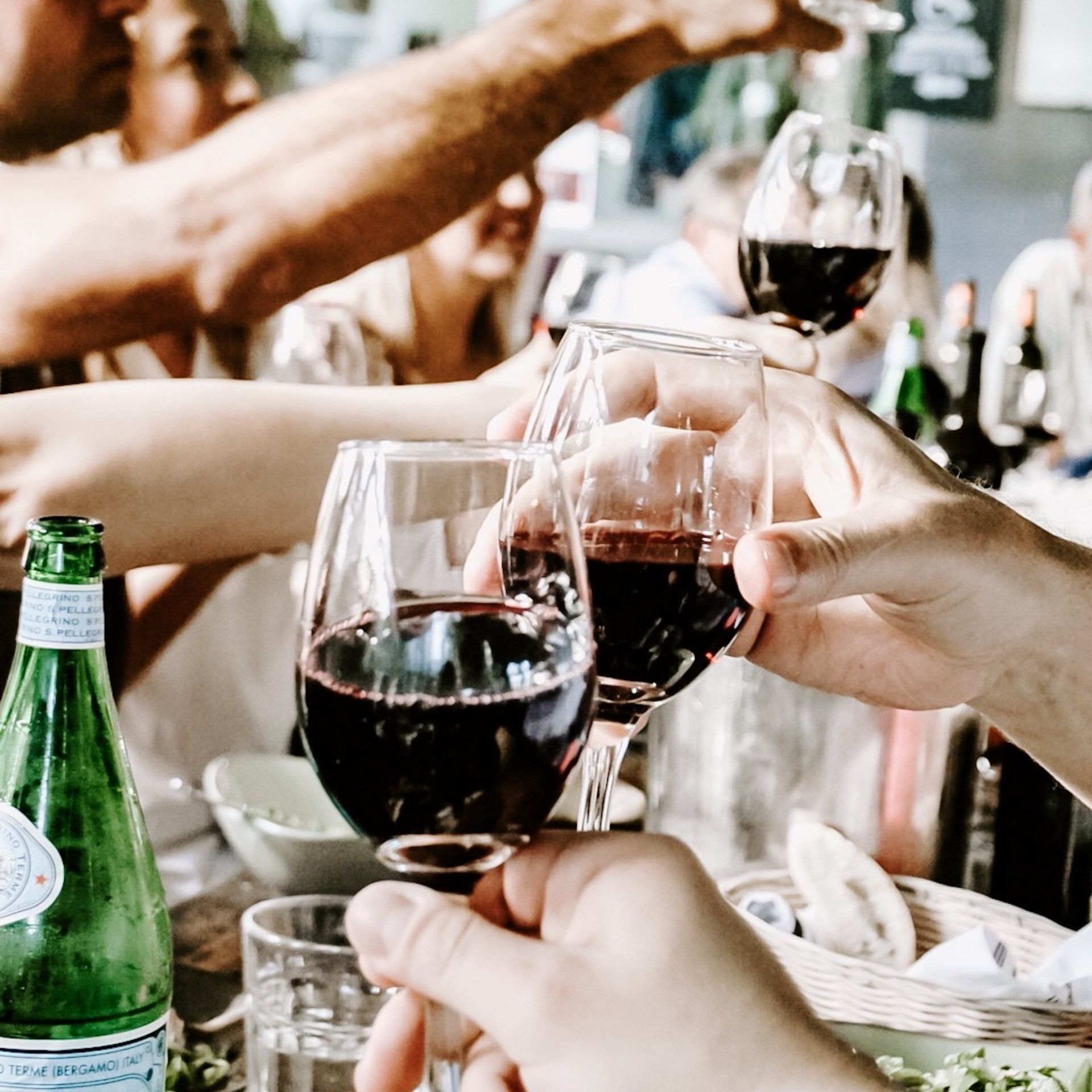 a group of people are toasting with wine glasses .
