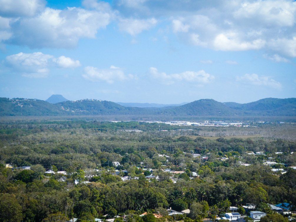 An Aerial View of a City Surrounded by Trees and Mountains — Action Air N Elec in Maroochydore, QLD