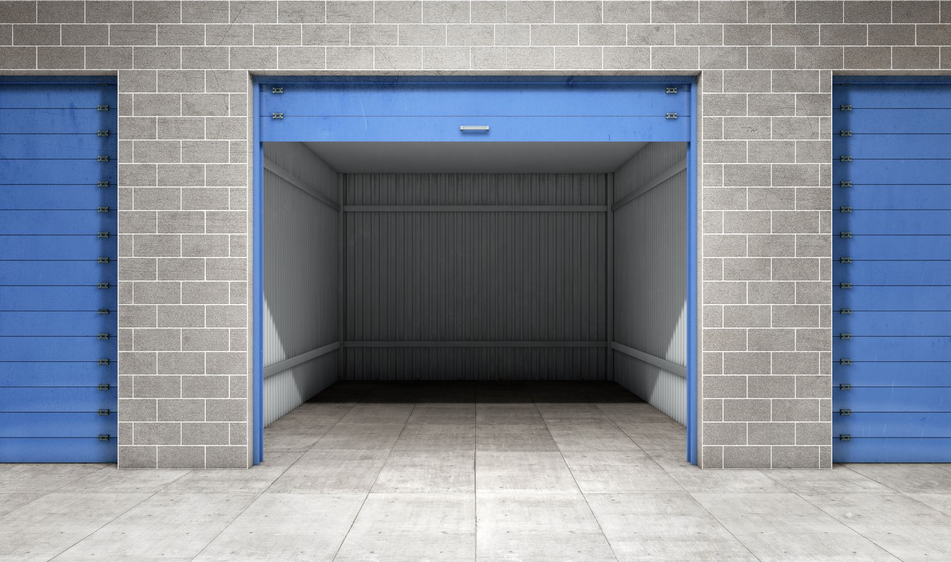 Open blue storage unit with two closed units flanking it, all in a gray brick building.