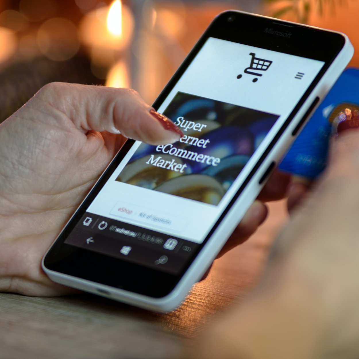 A person is holding a cell phone that says super internet ecommerce market