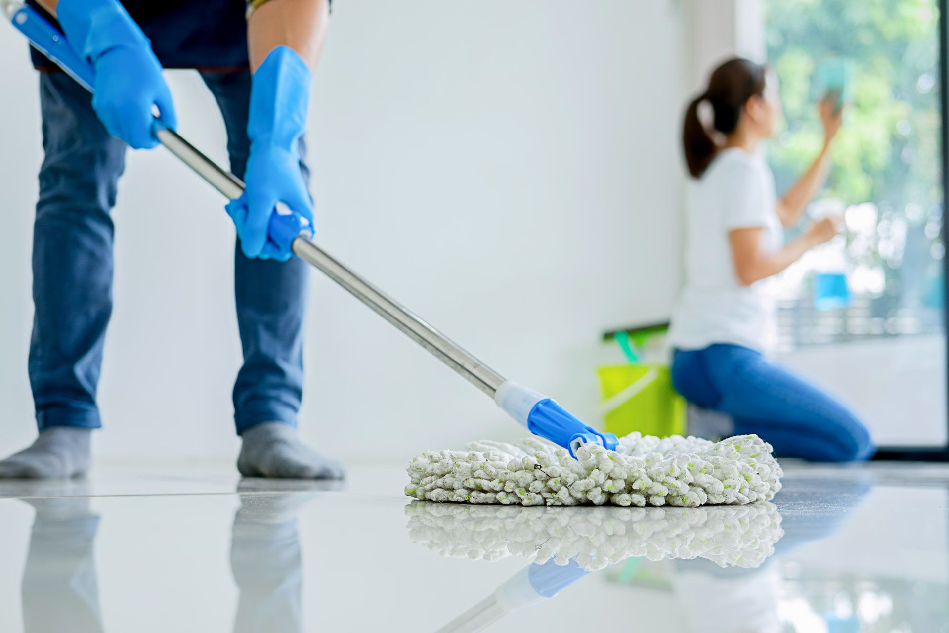 Cleaners employee removing dirt with equipment in office.