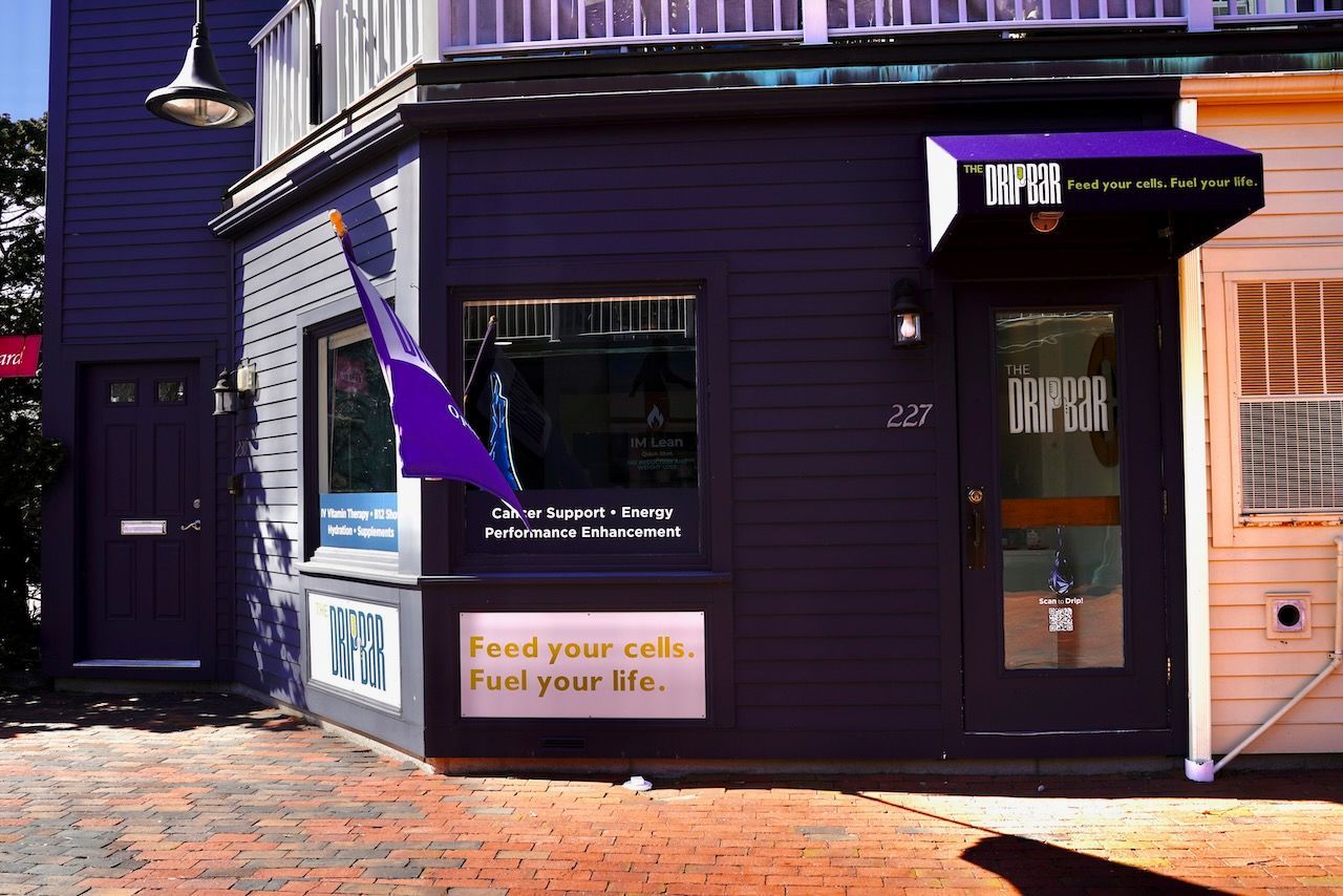 A purple building with a sign that says feed your cafe find your life