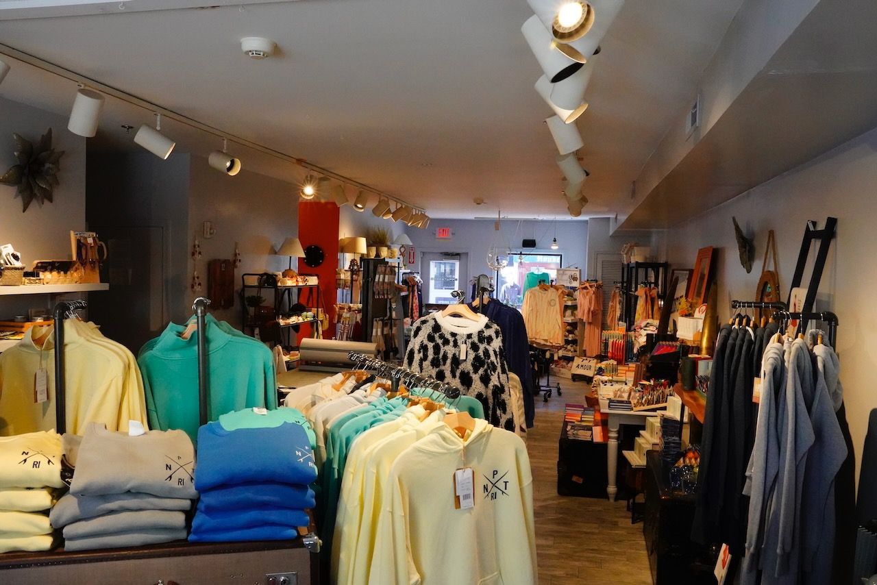 A clothing store with a lot of clothes on display