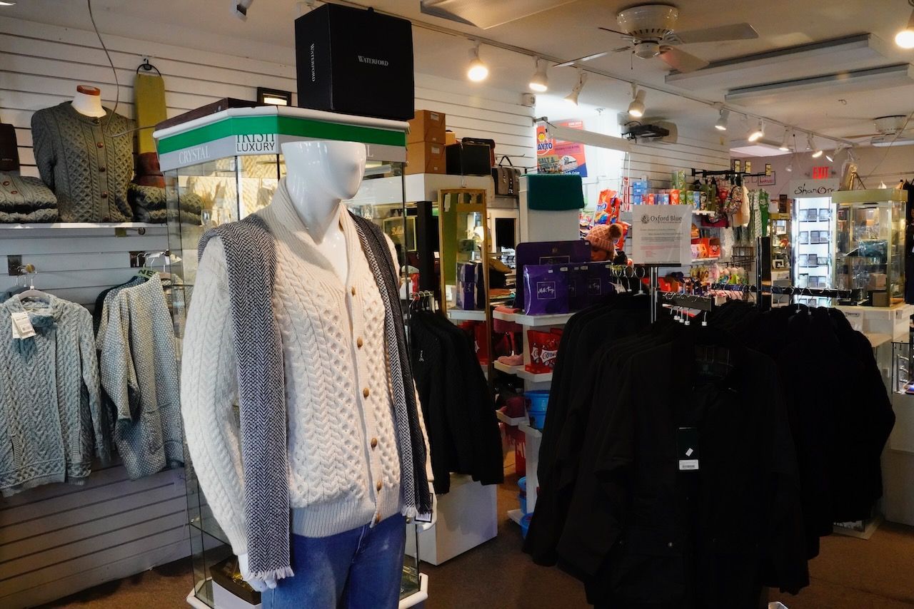 A mannequin is wearing a sweater in a store.