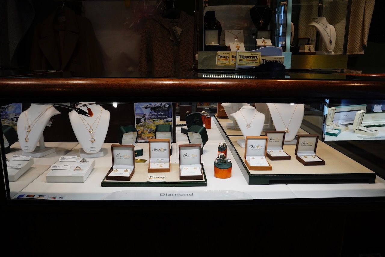 A display case with necklaces and rings on it