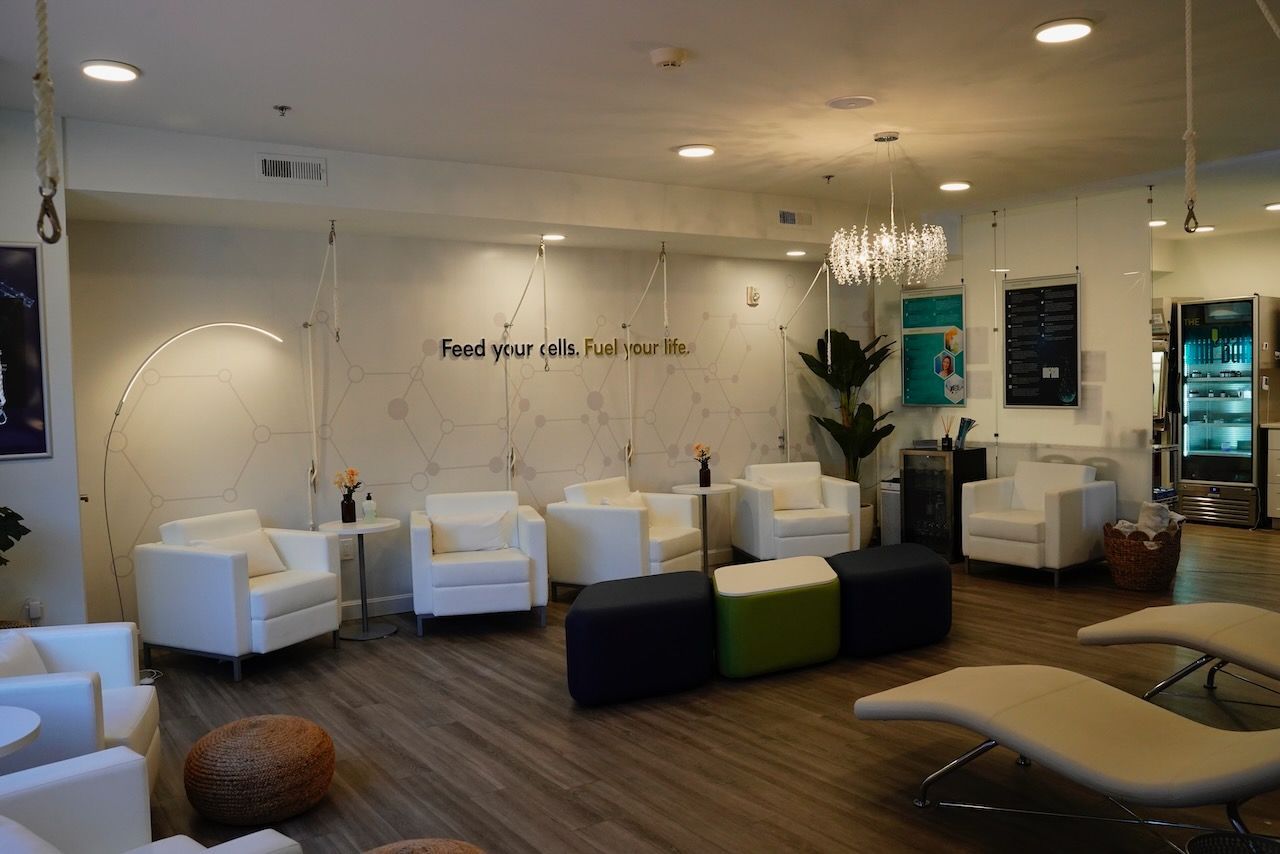 A living room with a lot of chairs and ottomans