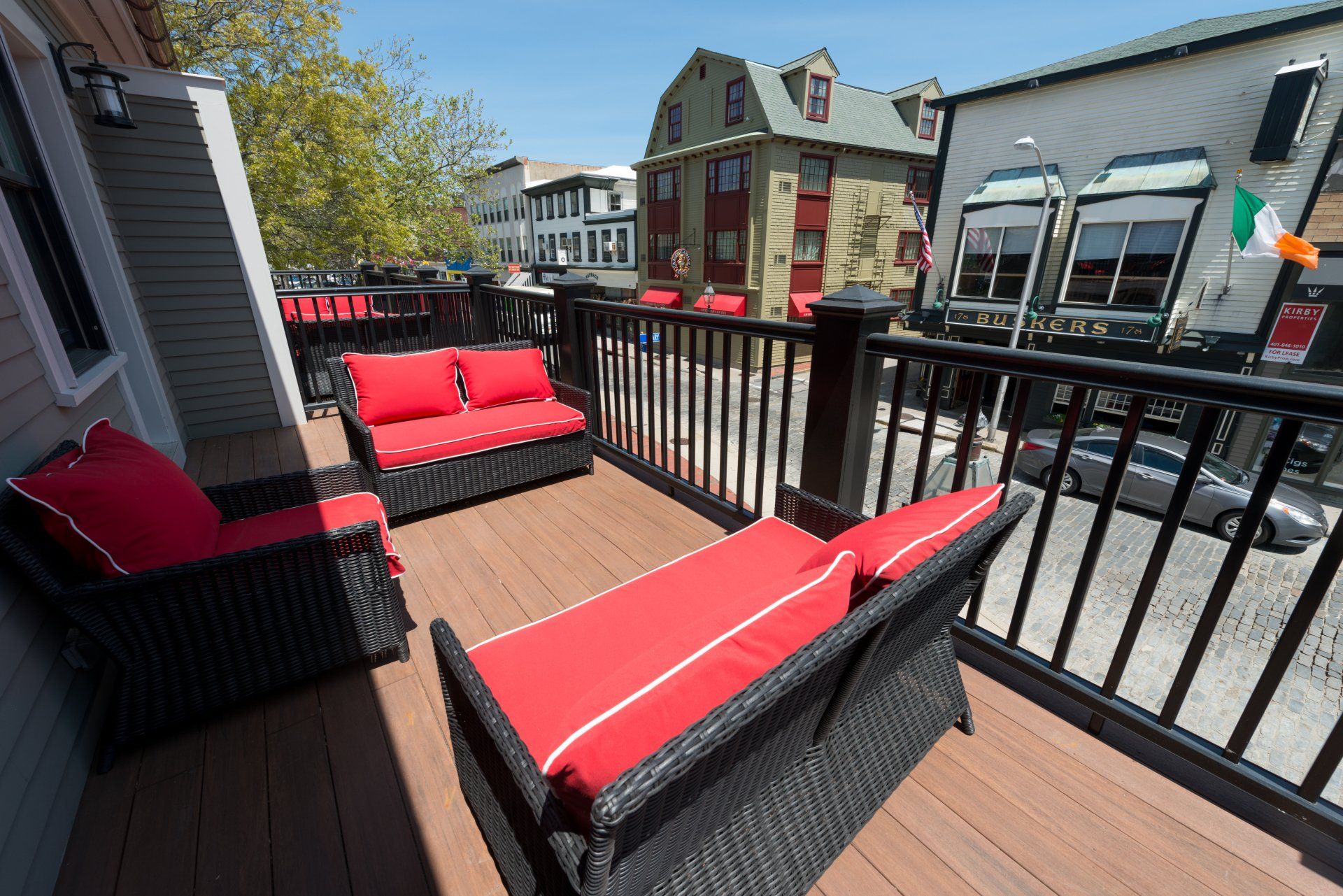 A balcony with a couch and chairs on it