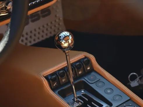 A close up of a shift knob in a car