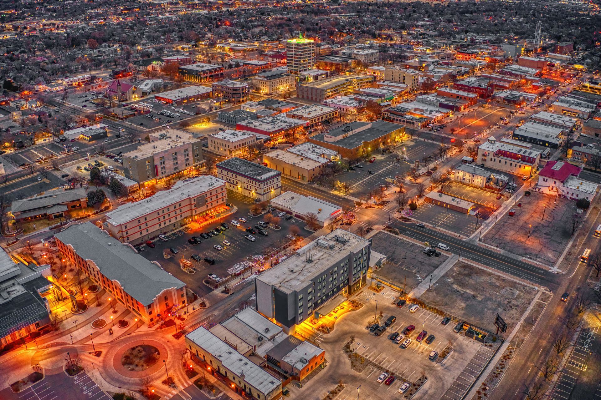 An aerial view of a city at night with lots of buildings.