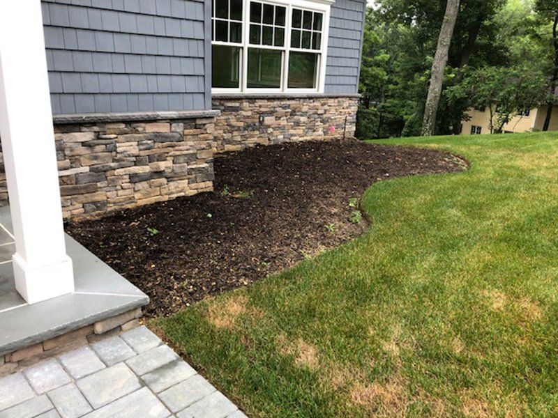 bottom half of home covered with light brown stones