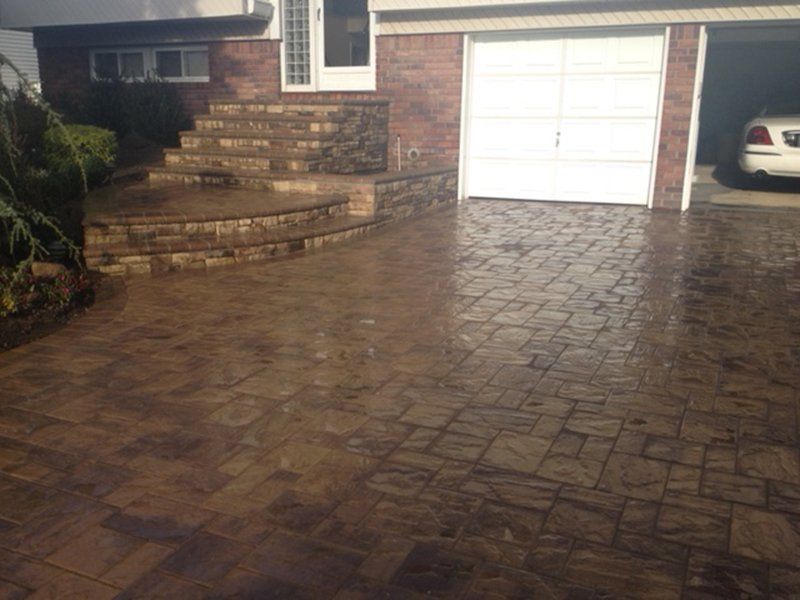wet brown stone long driveway and stone steps