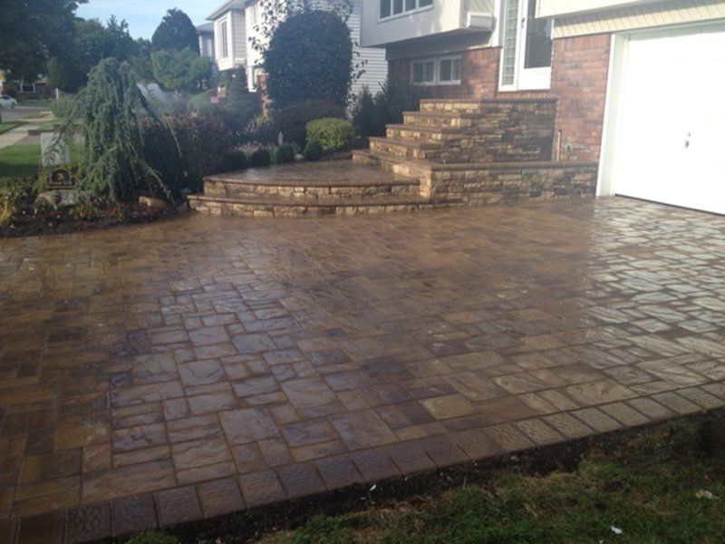 wet brown stone long driveway and stone steps