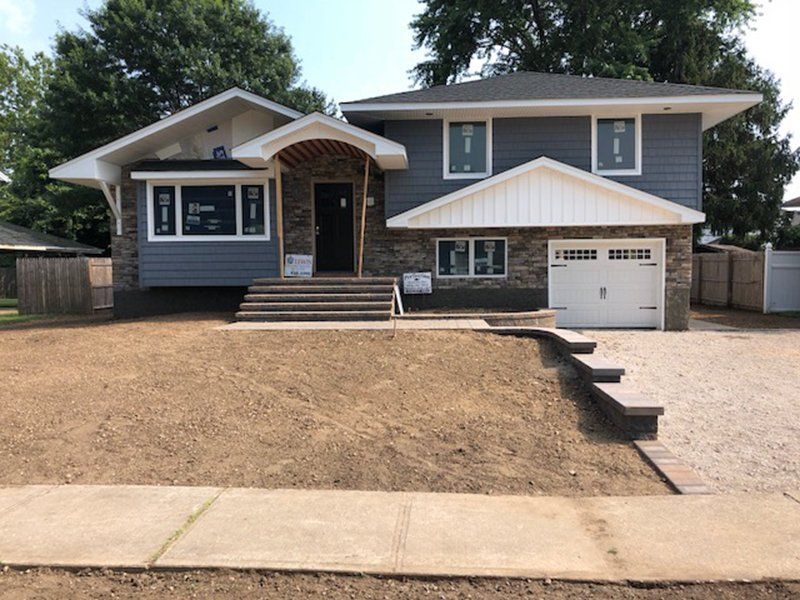 front of house with stone work steps, walkway and driveway