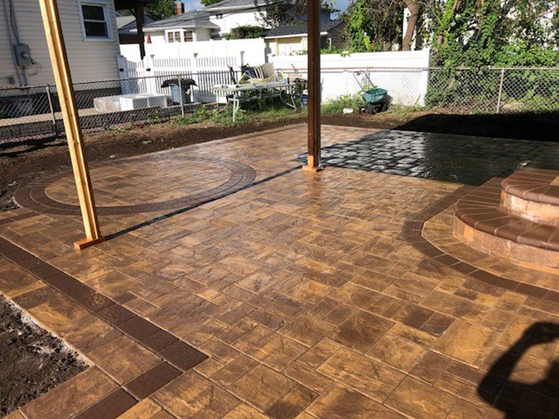 patio made of brown and wet dark brown bricks with a circle design in the patio