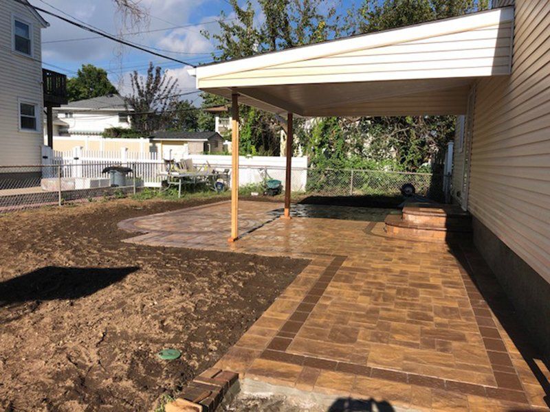 patio made of brown and wet dark brown bricks with a circle design in the patio
