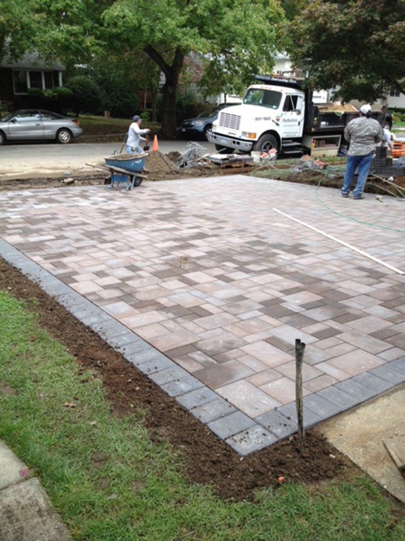 men working on a driveway
