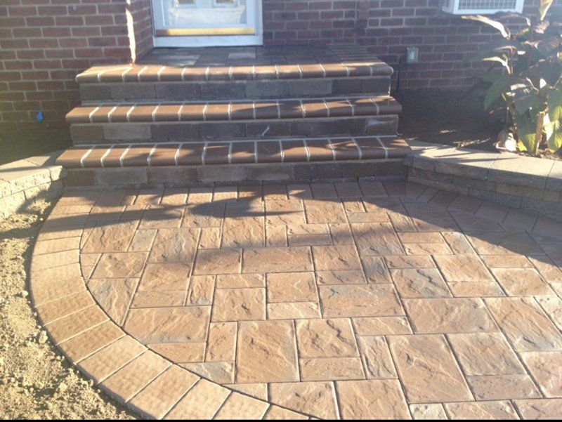 red stone stoop leading to stone patio