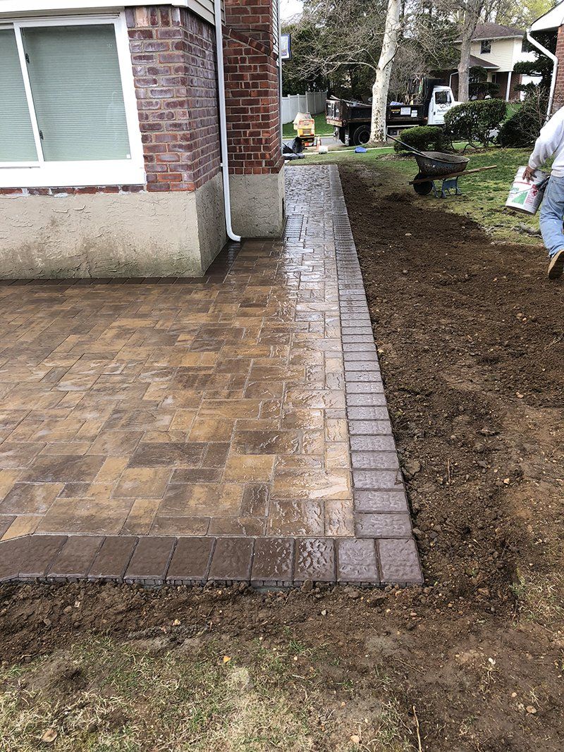 light brown stone walkway on side of house