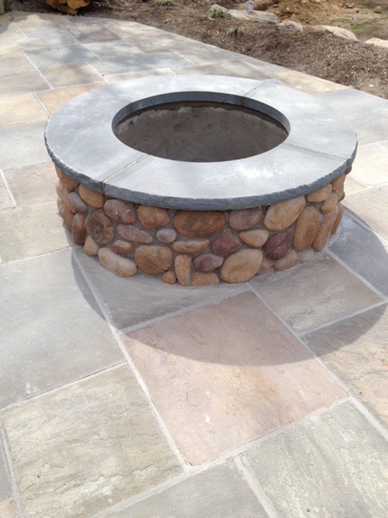 round fire place with round rocks around it's base