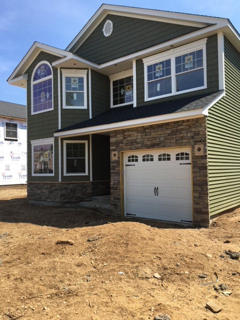 newly constructed home with bottom have having grey stone work