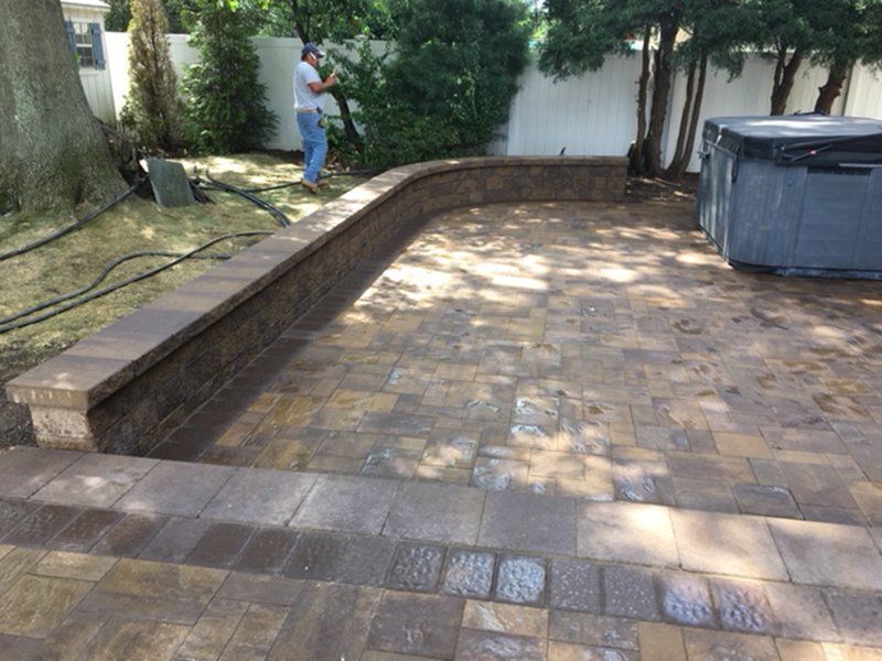 brown stone brick patio with a brown stone fence around it
