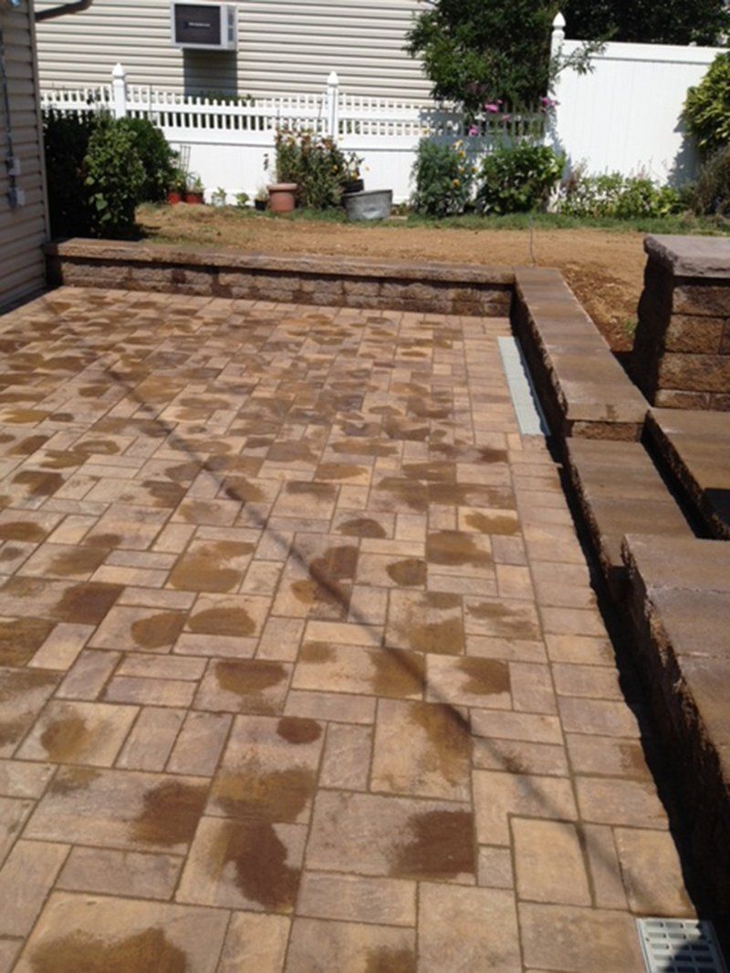 red stone brick pation with brick steps leading to garden