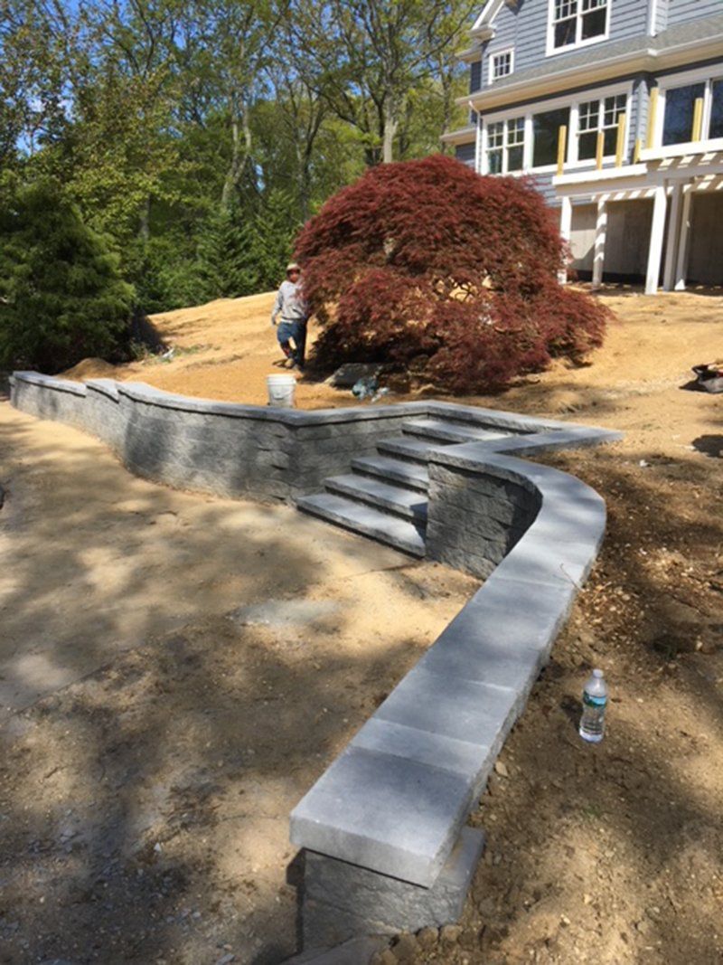 low grey fence stone wall with steps