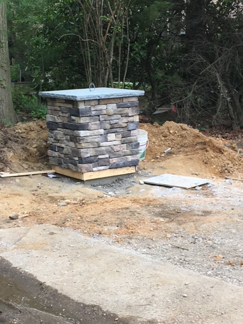 small grey brick light post with light grey slate top