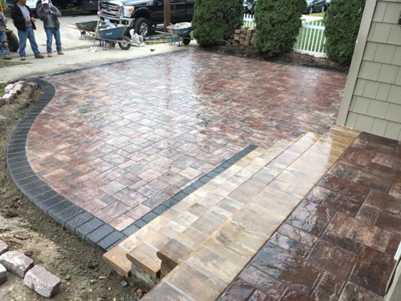 wet drive way with different color bricks