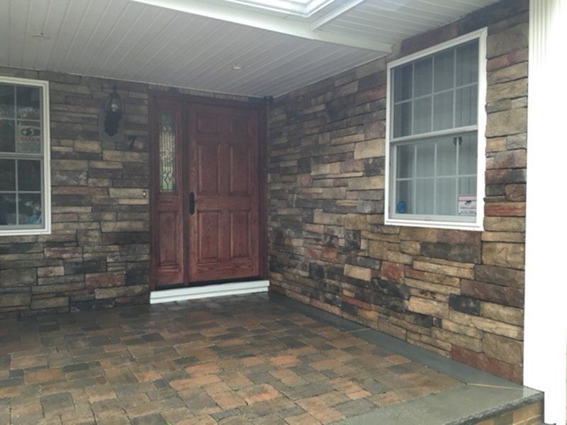 multi colored stone bricks around the red front door