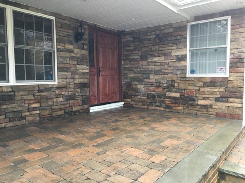 multi colored stone bricks around the red front door