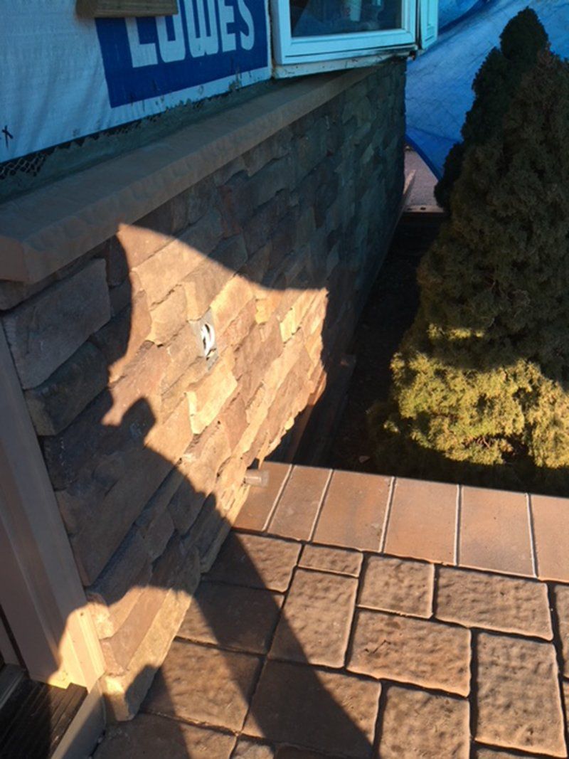 side wall of house made of brown stone bricks