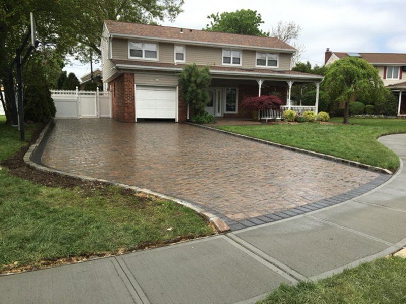 driveway in front a house with a white garage door
