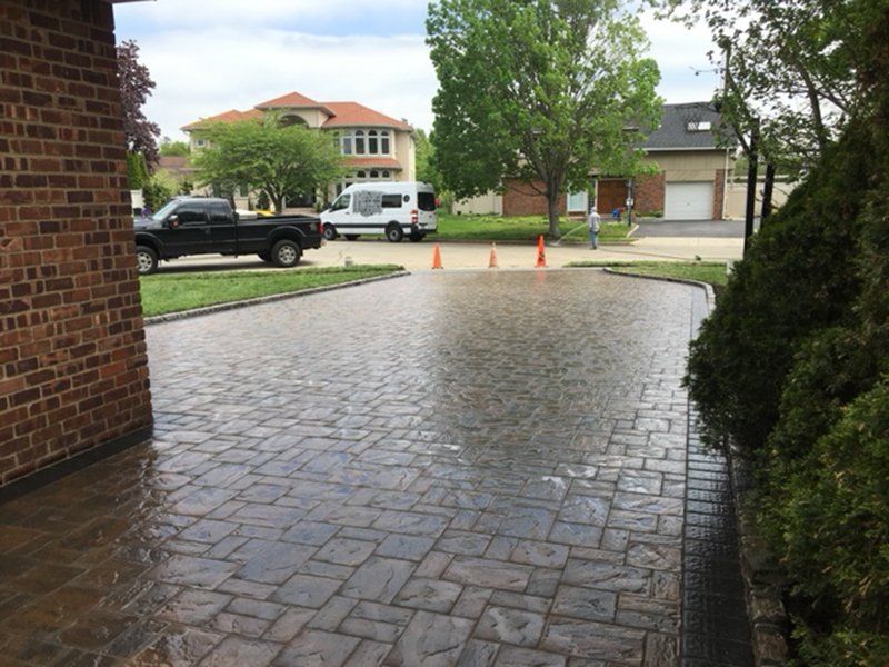 wet brick Driveway with 3 orange cones