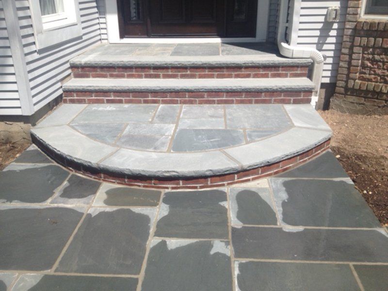 red brick stoop with grey stone steps