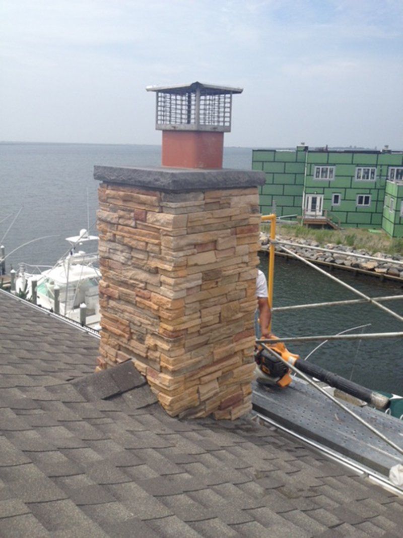 brown brick chimney with a black slate top