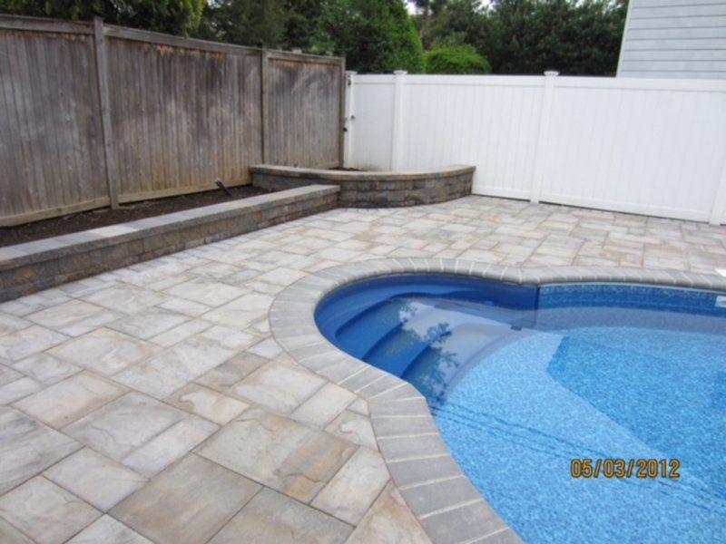 A in ground pool with steps leading into it.