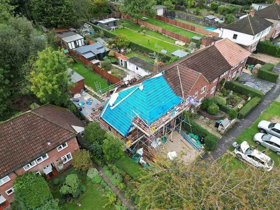 An aerial view of a house under construction in a residential area.