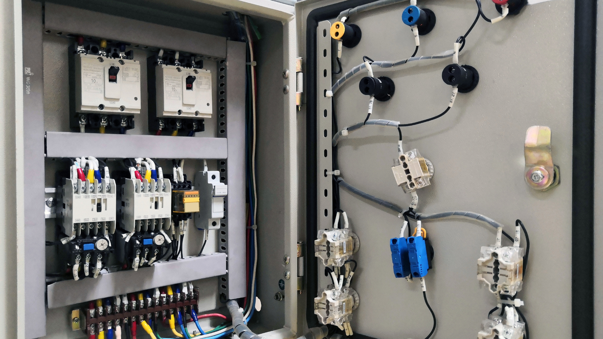 Electrical control panel with various circuit breakers, wiring, and components.