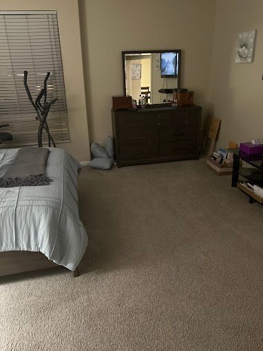 Cleaned bedroom with dresser, TV, and exercise equipment by Los Angeles maid service professionals