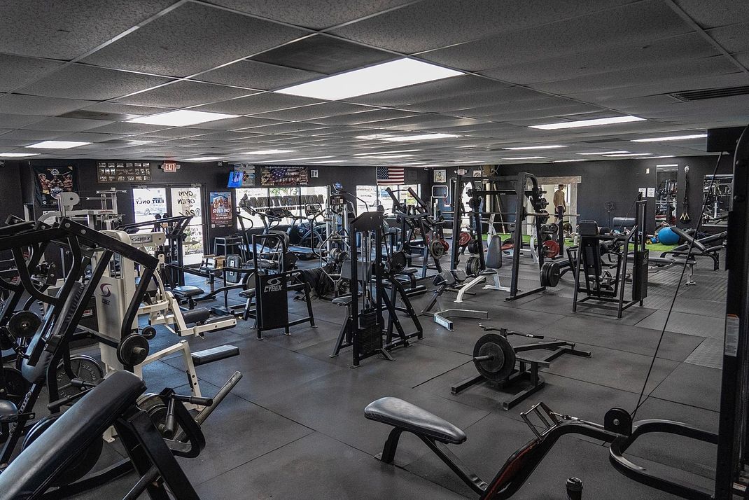 A large gym filled with lots of exercise equipment