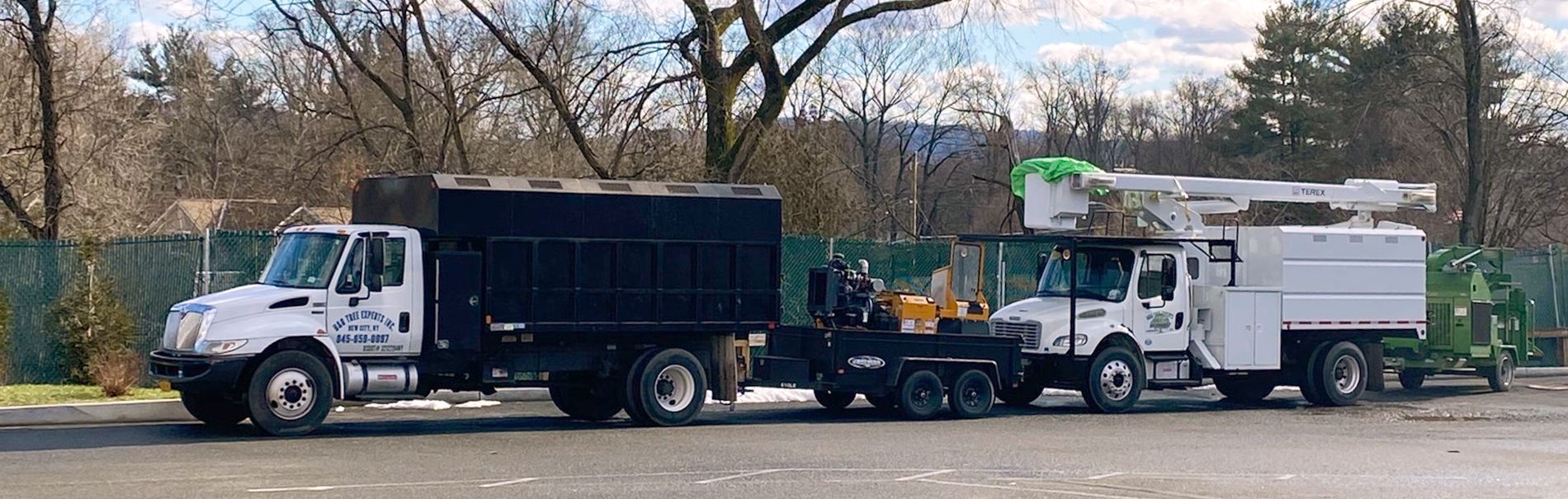 Two trucks are parked next to each other in a parking lot.